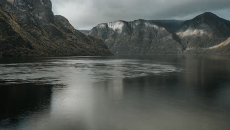 view to aurladsfjord in western norway with strong current in the foreground