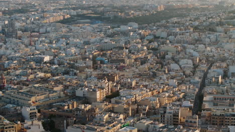 Aerial-view-panning-overlook-of-unique-architecture-of-Malta,-on-a-sunny-evening