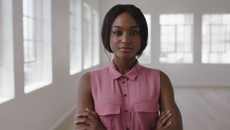 slow motion portrait of young stylish african american woman smiling confident looking boss at camera arms crossed in apartment background