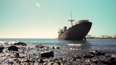 rusty shipwreck on rocky coast