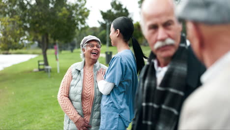 nurse talking with elderly people in the park