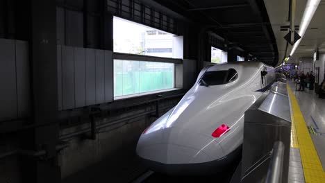 bullet train pulls into a busy platform