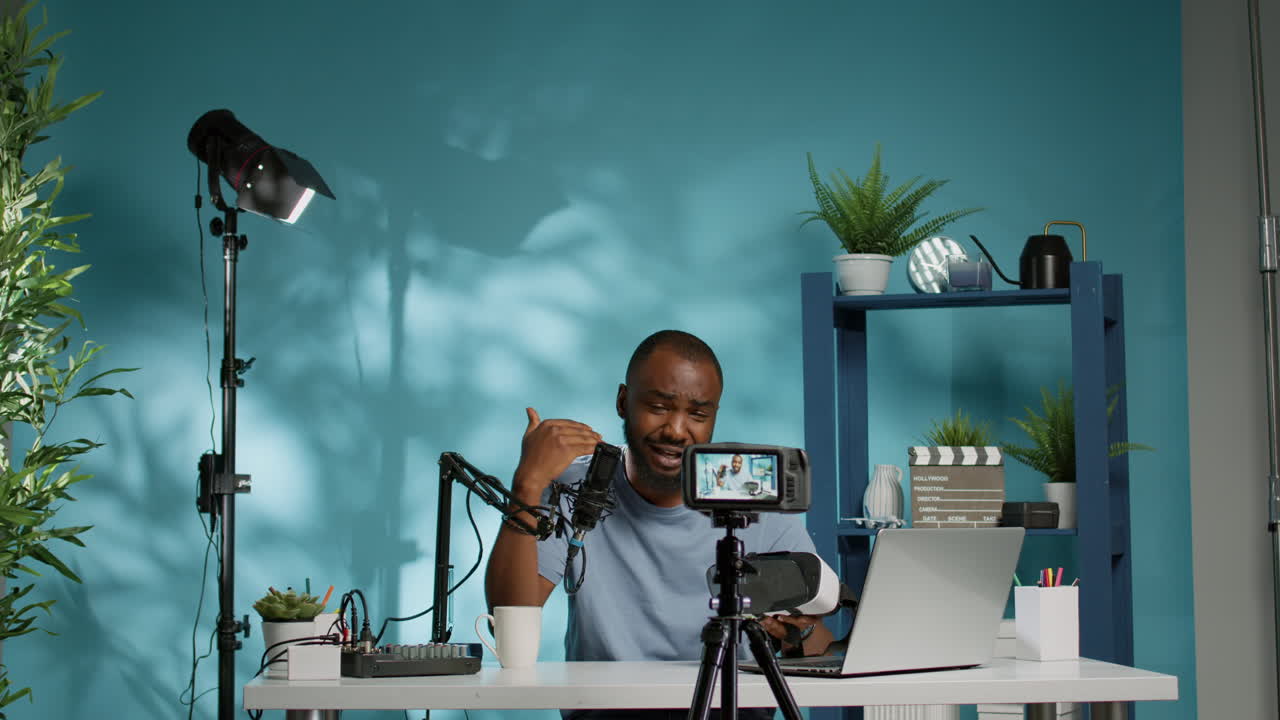 African american vlogger holding vr glasses to review product