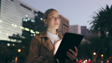 businesswoman using tablet in city at night