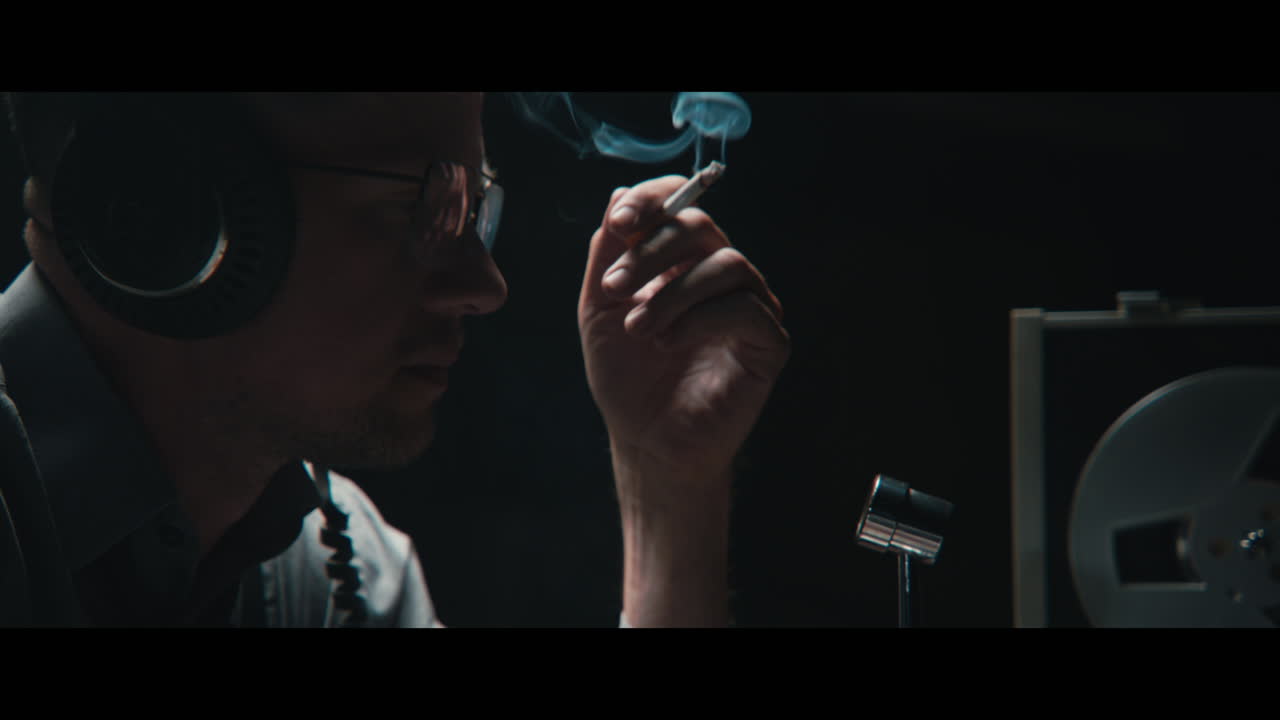 An intelligence officer listens to the wiretap recordings