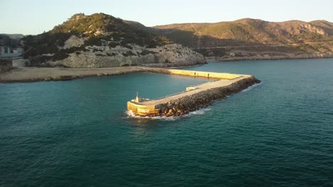 A-cement-factory-near-costa-garraf-coastline-in-barcelona,-spain-at-golden-hour,-aerial-view