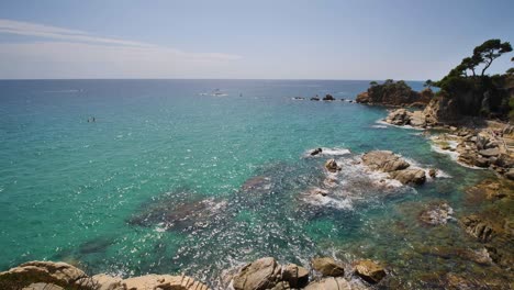 Beautiful-Mediterranean-beach-of-the-Costa-Brava-Girona-leafy-green-vegetation-and-turquoise-blue-sea