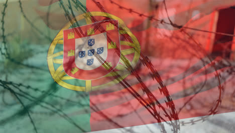 alambre de púas contra la bandera portuguesa