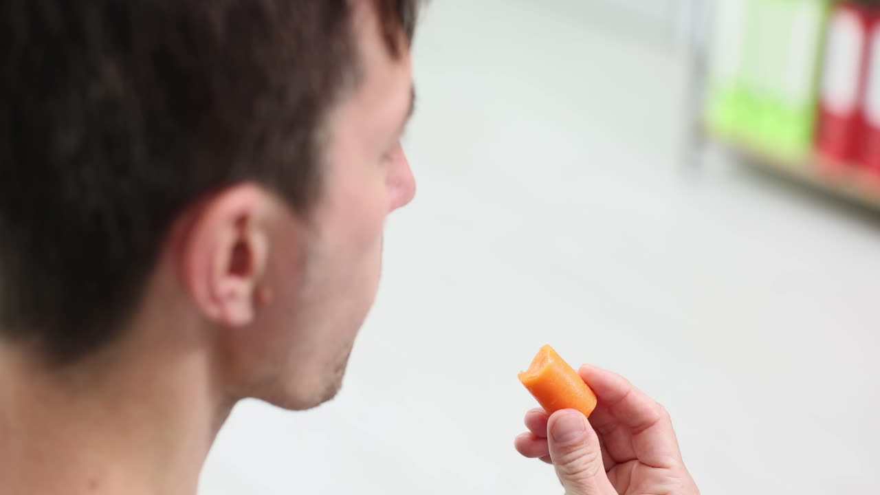 Man eating a healthy carrot snack