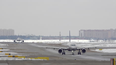 planes taxiing on the snowy runway