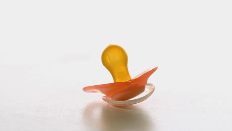 yellow soother spinning on a surface