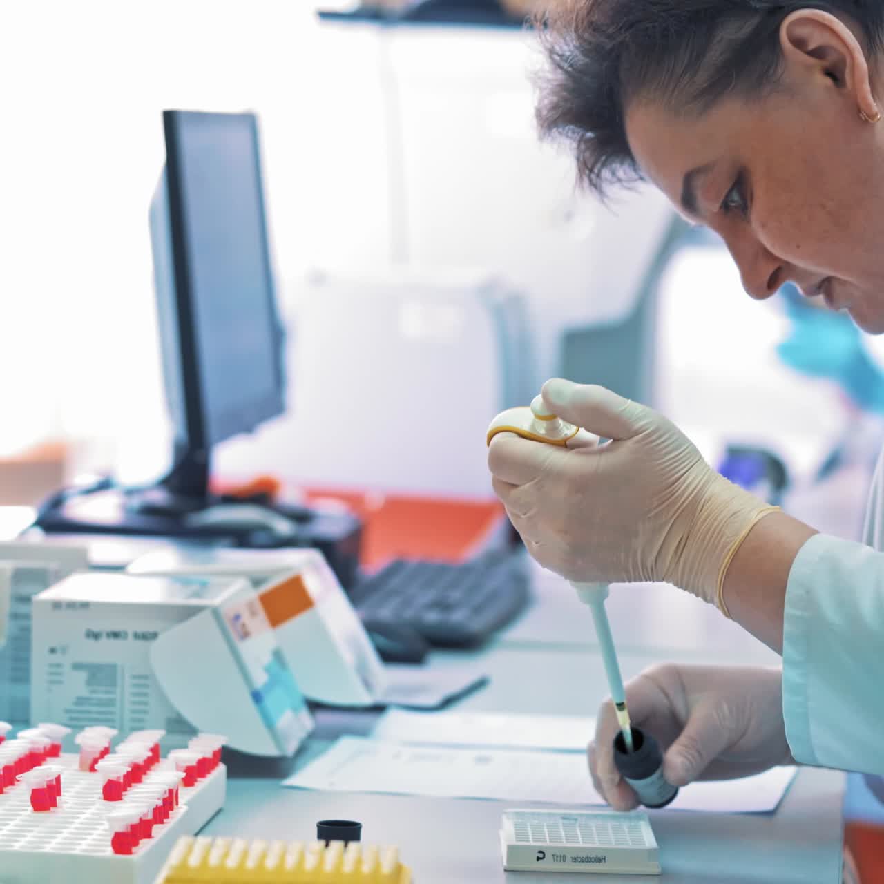 Scientist pipetting liquids for research