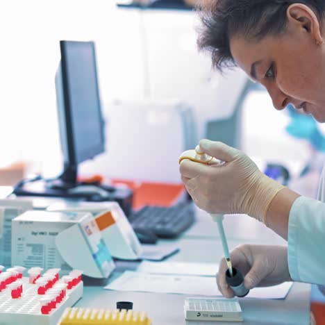 scientist pipetting liquids for research