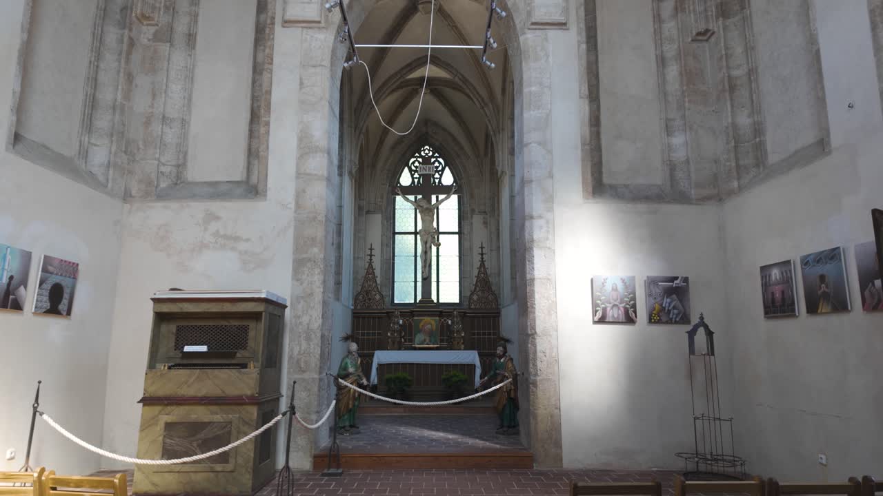 Interior of Sedlec Ossuary, showcasing a historic altar set within the stunning Gothic architecture of this unique Czech landmark.