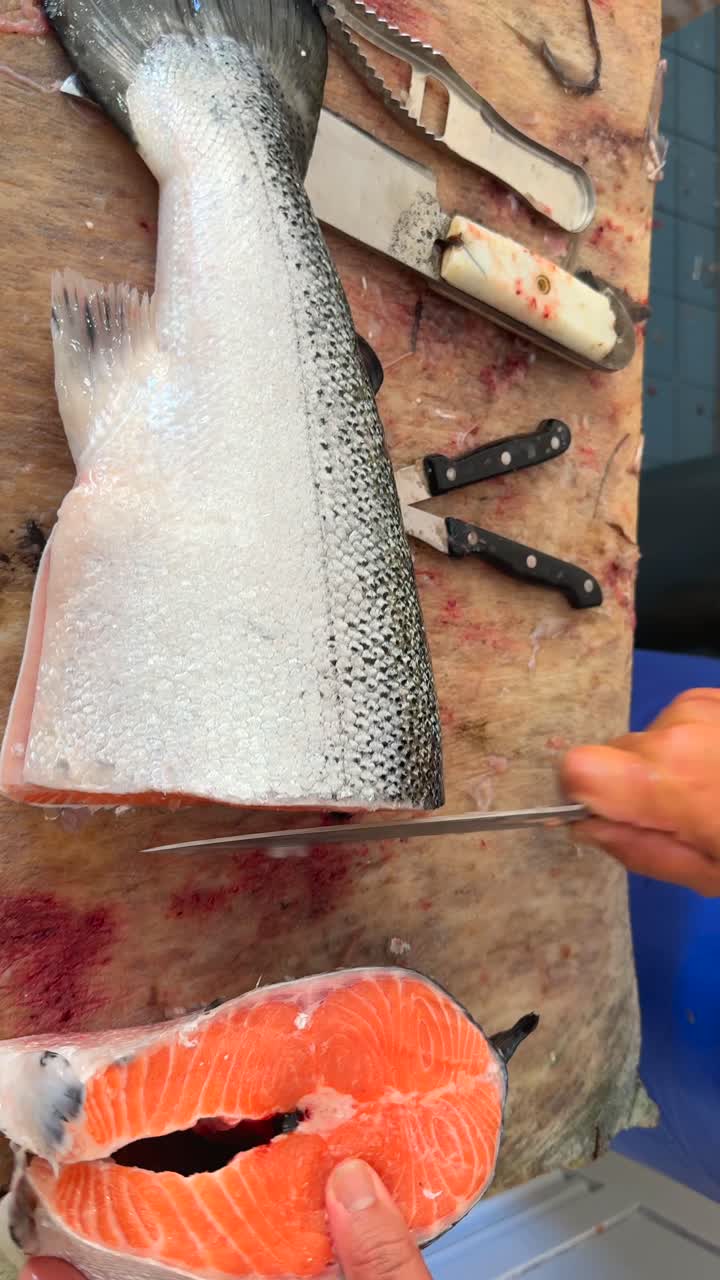 Filleting salmon at a fish market