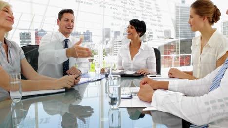 Animation-of-graphs-and-trading-board-over-diverse-coworkers-shaking-hands-after-meeting