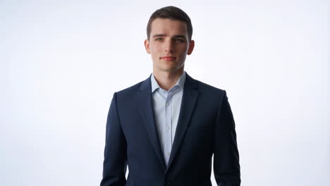 young man in a dark suit against a white background