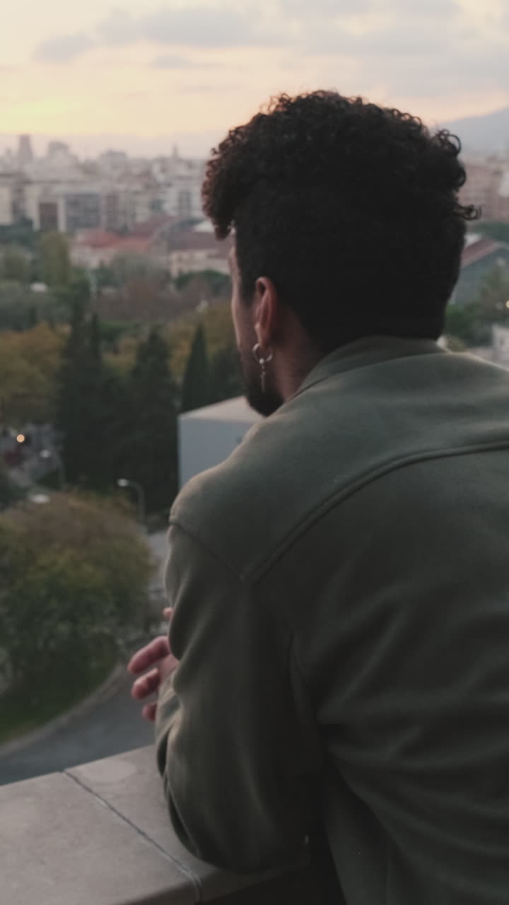 Man Looking at City View at Sunset