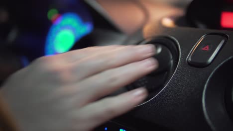 man's hand hitting car emergency light button