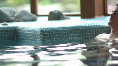 attractive couple relaxing in swimming pool