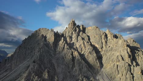 mountain peaks of cadini di misurina in the dolomites at sunset, backwards aerial