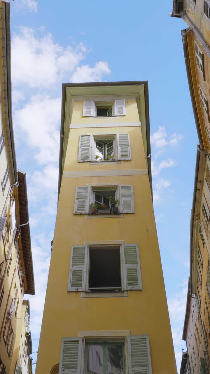 Tall Yellow Building in a Narrow European Alley