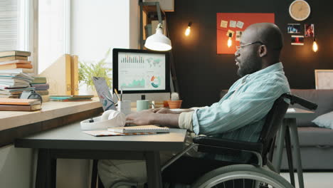 african american man with disability working from home