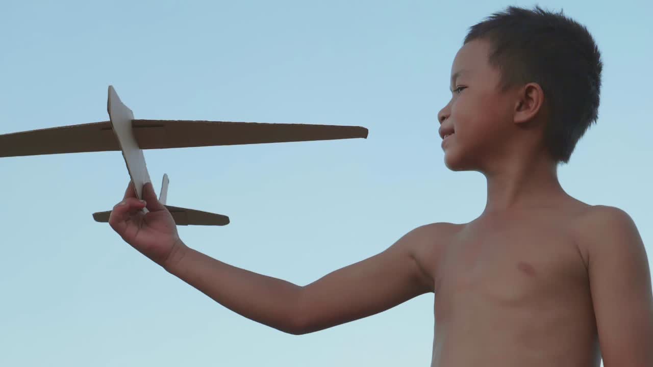 Child playing with a paper airplane