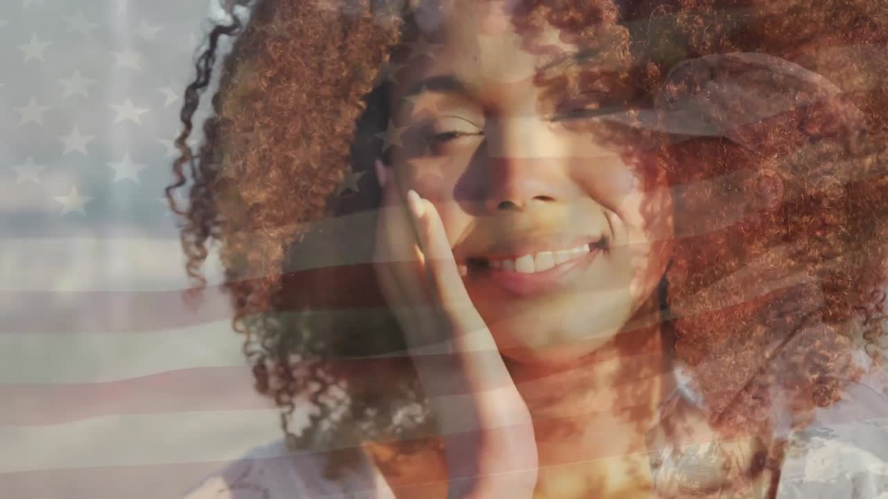 Animation of flag of united states of america over african american woman on beach