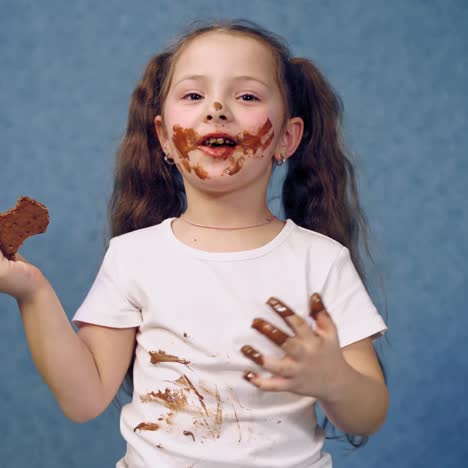. girl with chocolate plate. little girl eating chocolate plate on table