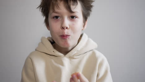 child eating an orange