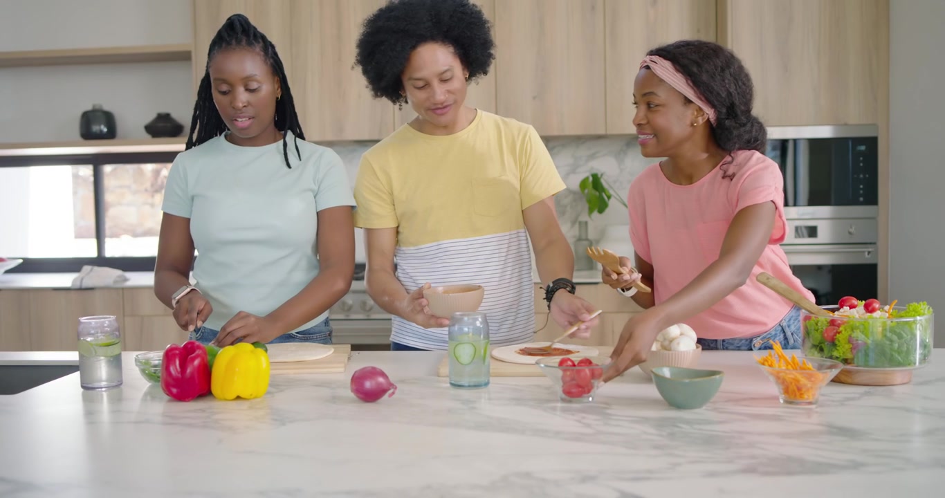 Family starting after prep, chopping veggies, assembling wraps and tossing salad preparing meal