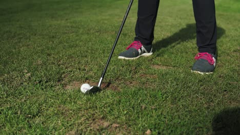 girl at golf training taking the shot