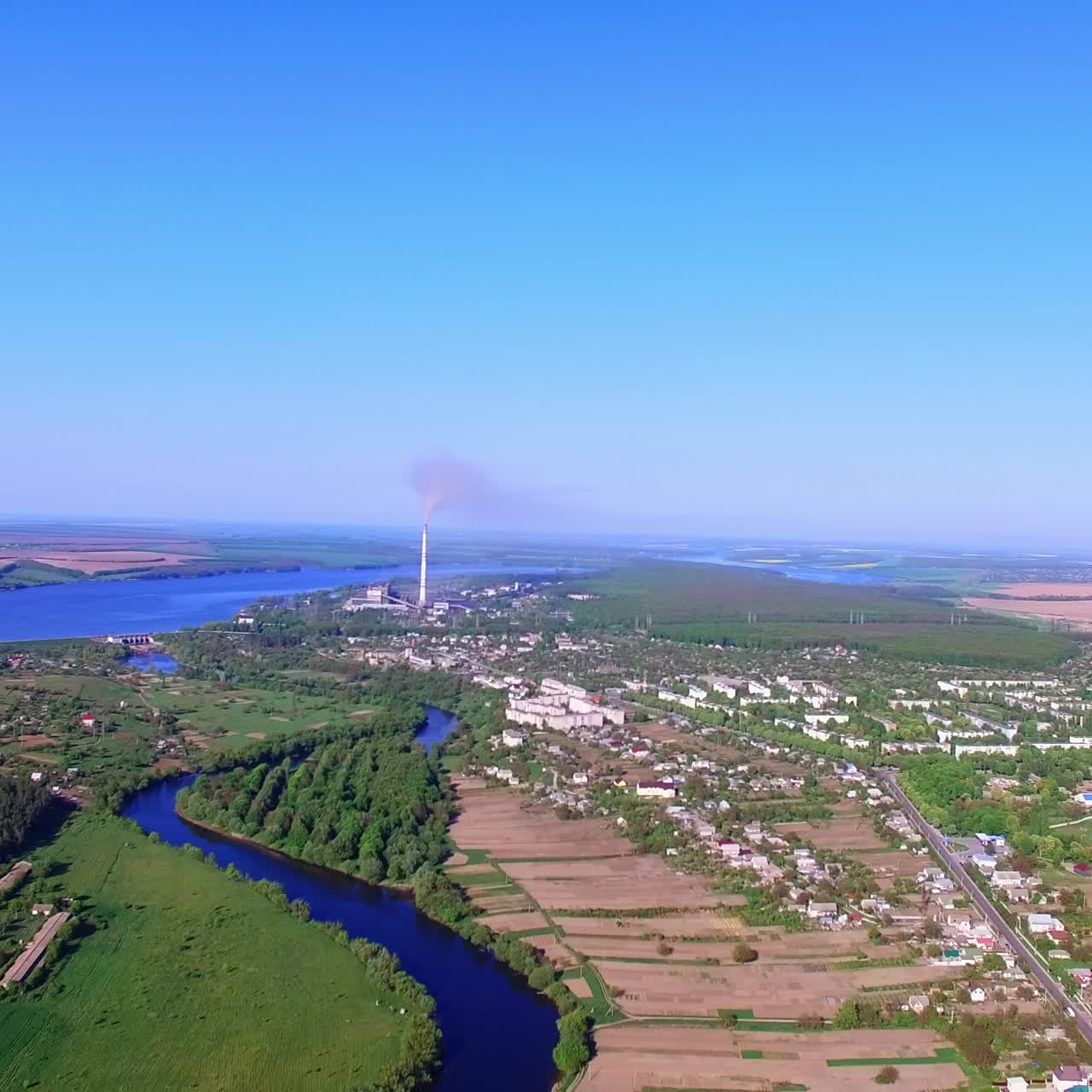Scenic picture of the big city on beautiful sunny day. Fantastic view of blue river flowing near the metropolis