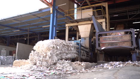 shredding machine with shredded cartons in recycling plant