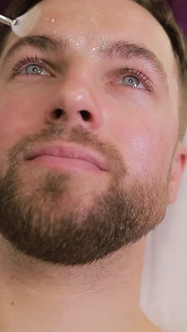 man receiving facial treatment