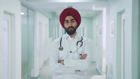 confident sikh indian doctor standing crossed hands