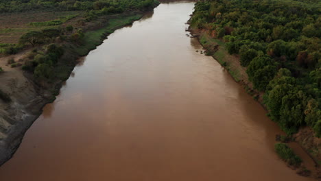 peaceful brown water of omo river near karo tribe village in omo valley, ethiopia