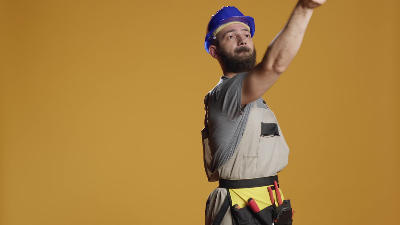 Portrait of construction worker using paintbrush and paitn color