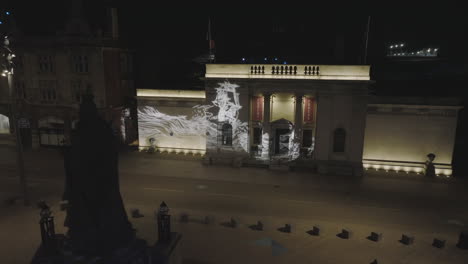 slow panning by the statue of queen victoria located in hull's queen victoria square, continuing into a fly around of the scrimshaw gobos projected onto ferens art gallery