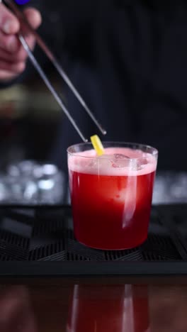 red cocktail at a bar