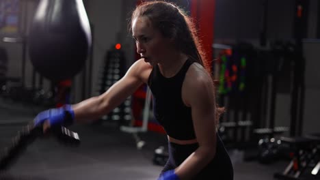 Female-Boxer-Doing-Some-Crossfit-Exercises-With-A-Rope-Indoor,-Side-View