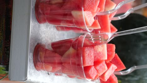 diced watermelon in plastic cups