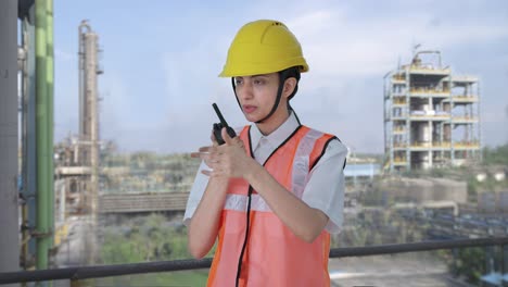 Indian-female-architect-giving-instructions-on-walkie-talkie