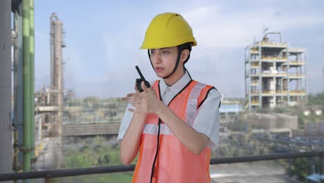 indian female architect giving instructions on walkie talkie