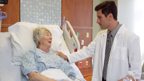 doctor talks to senior patient in hospital bed shot on r3d