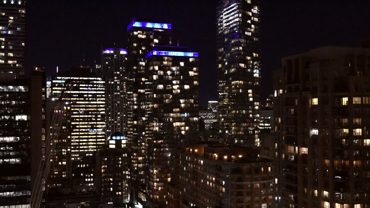 Night View of City Skyline with Illuminated Buildings