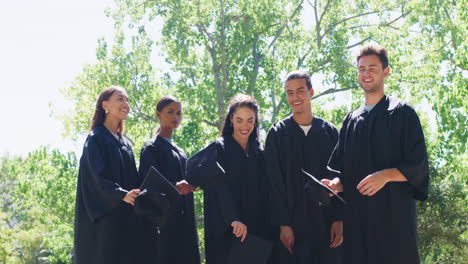 Group-of-graduates-celebrating-and-throwing-caps