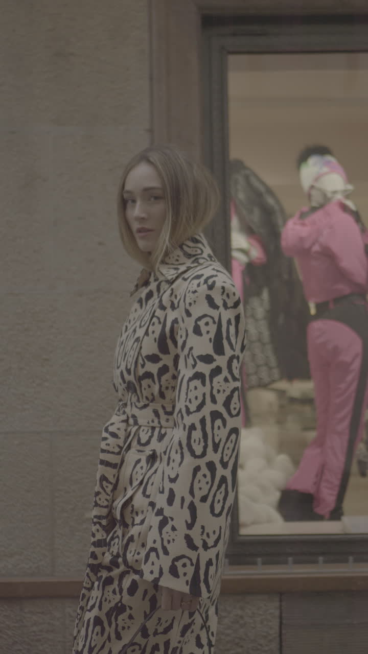 Woman Wearing Leopard Print Coat in Front of Store