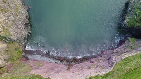 aerial-looking-directly-down-on-a-hidden-cove-on-The-Copper-Coast-Waterford-on-a-calm-winter-morning